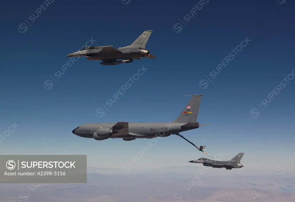 Two F-16's from the 56th Fighter Wing at Luke Air Force Base, Arizona, prepare to refuel from a KC-135 on a training mission over the Arizona desert.