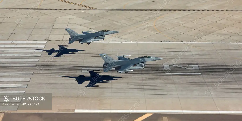 Two F-16's from the 56th Fighter Wing at Luke Air Force Base, Arizona, land in formation on runway 21.