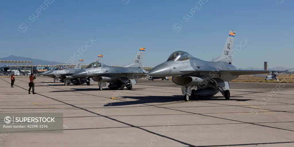 F-16's from the 162nd Fighter Wing line up at the end of the runway for preflight checks at the Tucson International Airport, Arizona.