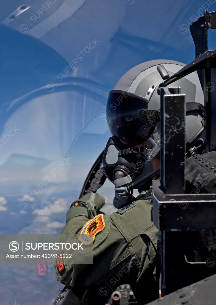 A F-15 pilot from the 173rd Fighter Wing looks over at his wingman during a training mission over Central Oregon.