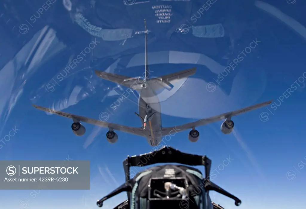 An F-15 Eagle pulls into pre-contact position behind a KC-135 Stratotanker during a training mission.