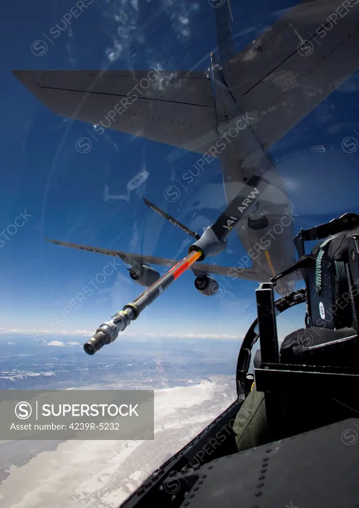An F-15 Eagle pulls into pre-contact position behind a KC-135 Stratotanker during a training mission.