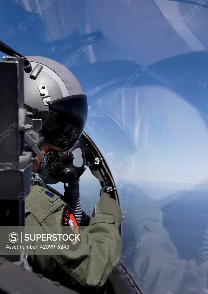 A F-15 pilot from the 114th Fighter Squadron looks over at his wingman during a training mission over Central Oregon.