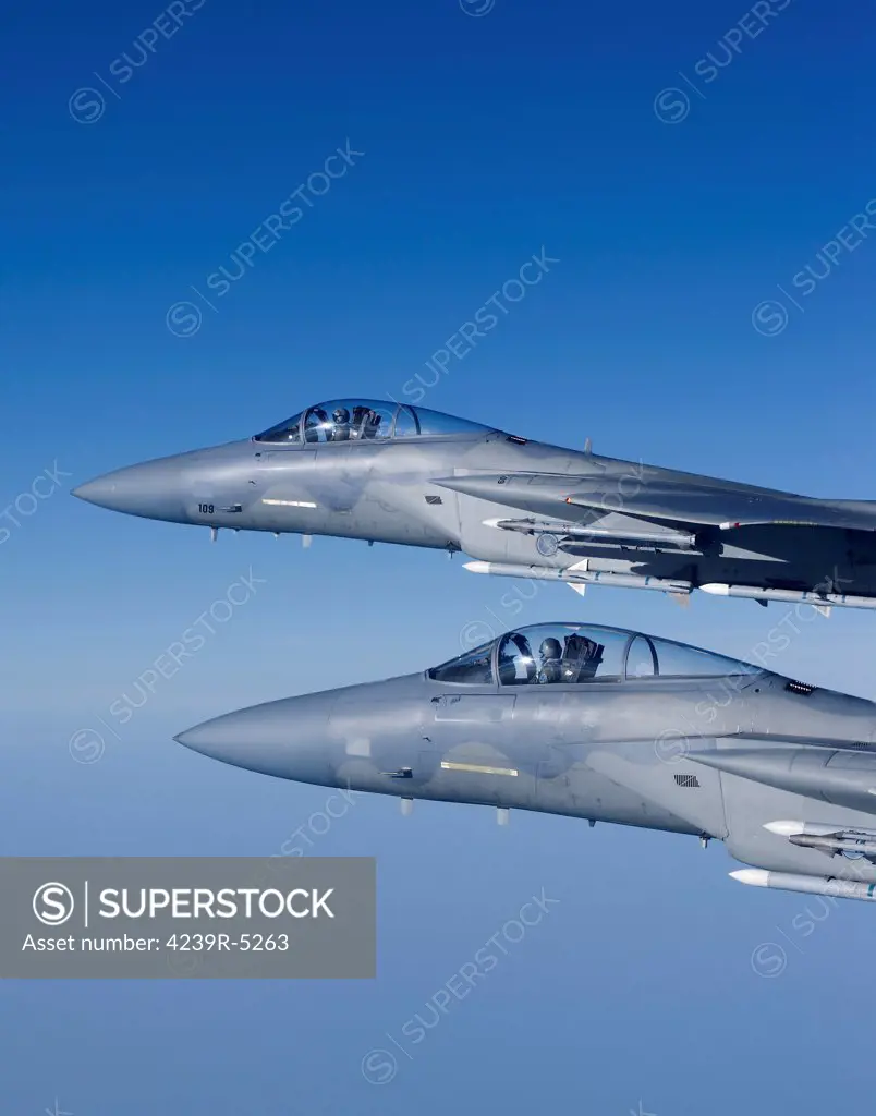 Two F-15 Eagles from the Massachusetts Air National Guard fly high over New England during a training mission.