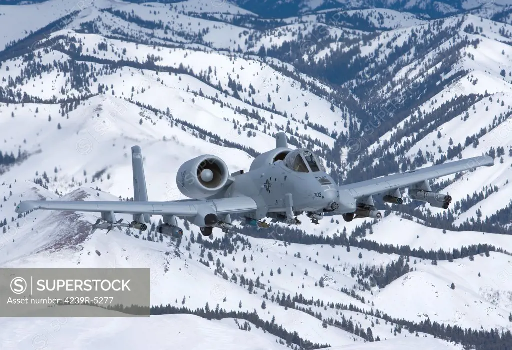 An A-10C Thunderbolt from the 190th Fighter Squadron flies over the snowy Idaho countryside on a training mission out of Boise, Idaho