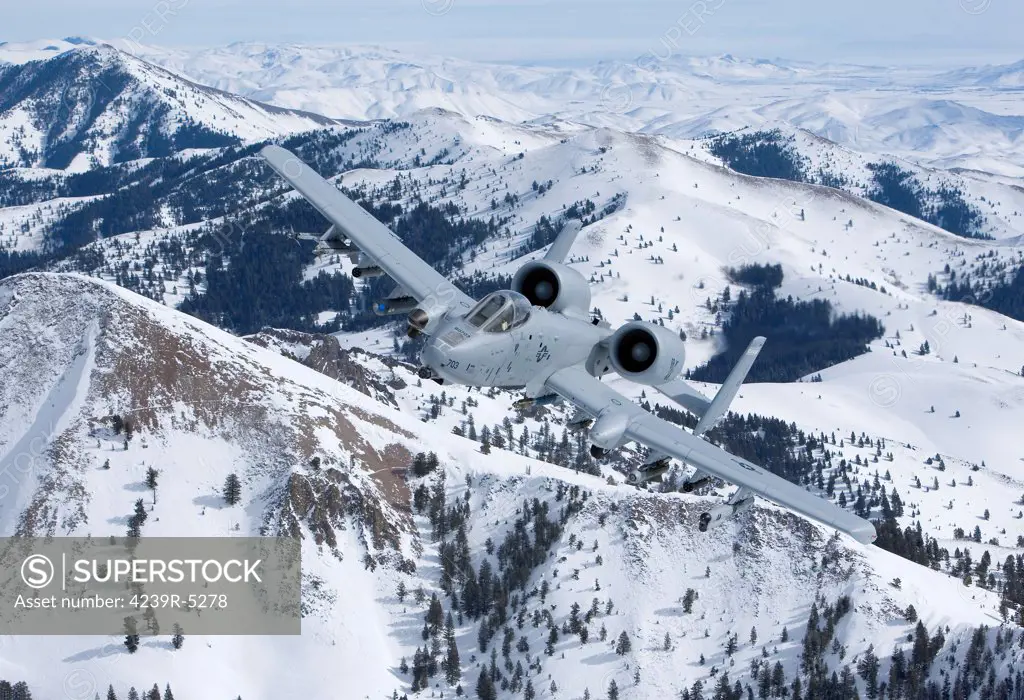 An A-10C Thunderbolt from the 190th Fighter Squadron flies over the snowy Idaho countryside on a training mission out of Boise, Idaho.