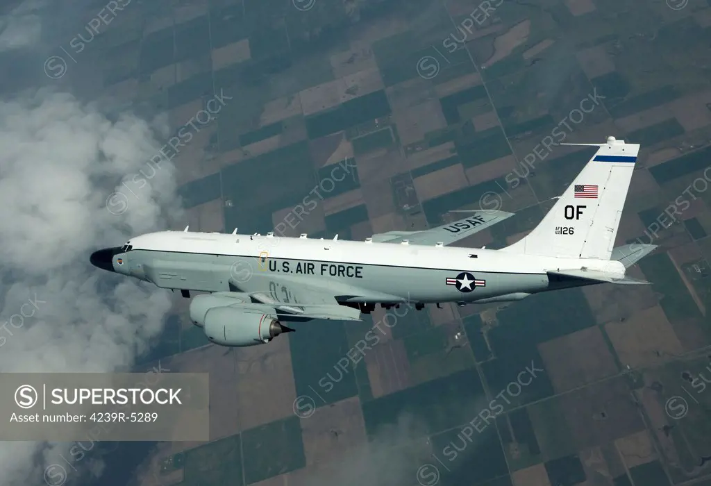 An RC-135W Rivet Joint aircraft flies high over the Midwest on a training mission out of Offutt Air Force Base, Nebraska.
