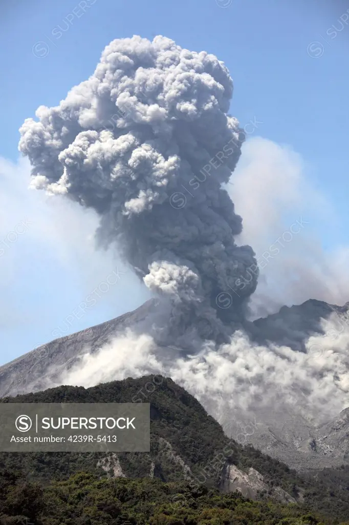 April 8, 2012 - Sakurajima volcano erupting. Ash cloud rising from Showa crater following powerful vulcanian eruption at Japans most active volcano. Fine ash is thrown up on flanks by impact of volcanic bombs.