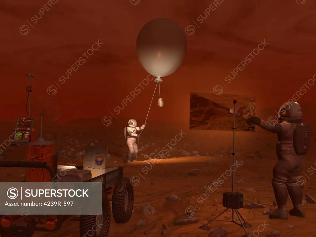 A titanian explorer prepares to release a weather balloon while another directs a flood lamp to illuminate the activity