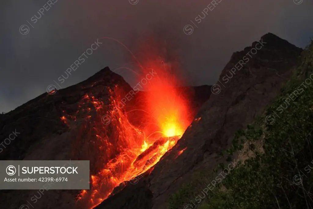 November 25, 2012 - Explosive strombolian type eruption of Batu Tara volcano, Komba Island, Indonesia. Trajectories of red glowing lava bombs are visible.