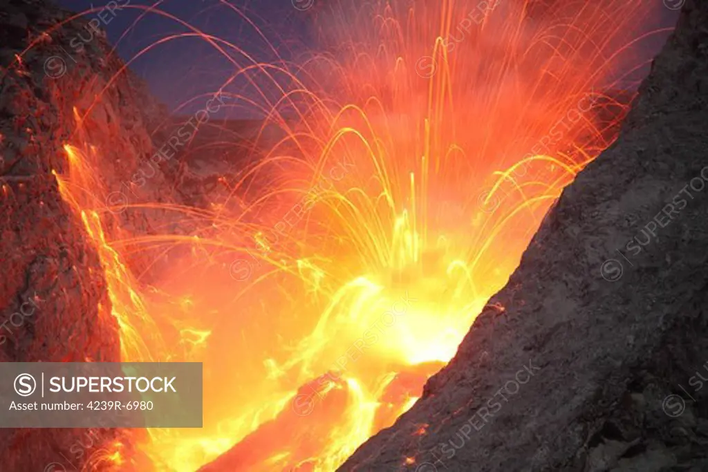November 26, 2012 - Explosive strombolian type eruption of Batu Tara volcano, Komba Island, Indonesia. Trajectories of red glowing lava bombs are visible.