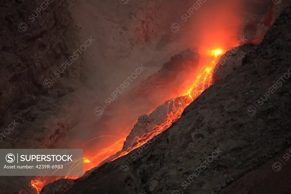 November 25, 2012 - Extrusion of lava through lava plug on top of conduit leads to small glowing rockfalls. Batu Tara volcano, Komba Island, Indonesia.