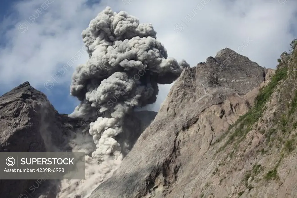 November 28, 2012 - Dense grey ash cloud from powerful explosive strombolian eruption rising from active crater of Batu Tara volcano, Komba Island, Indonesia.