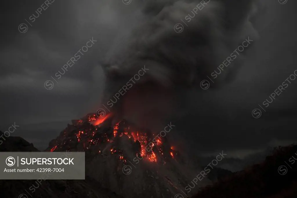 November 30, 2012 - Glowing Rerombola lava dome of Paluweh volcano during ash venting phase, Flores, Indonesia.