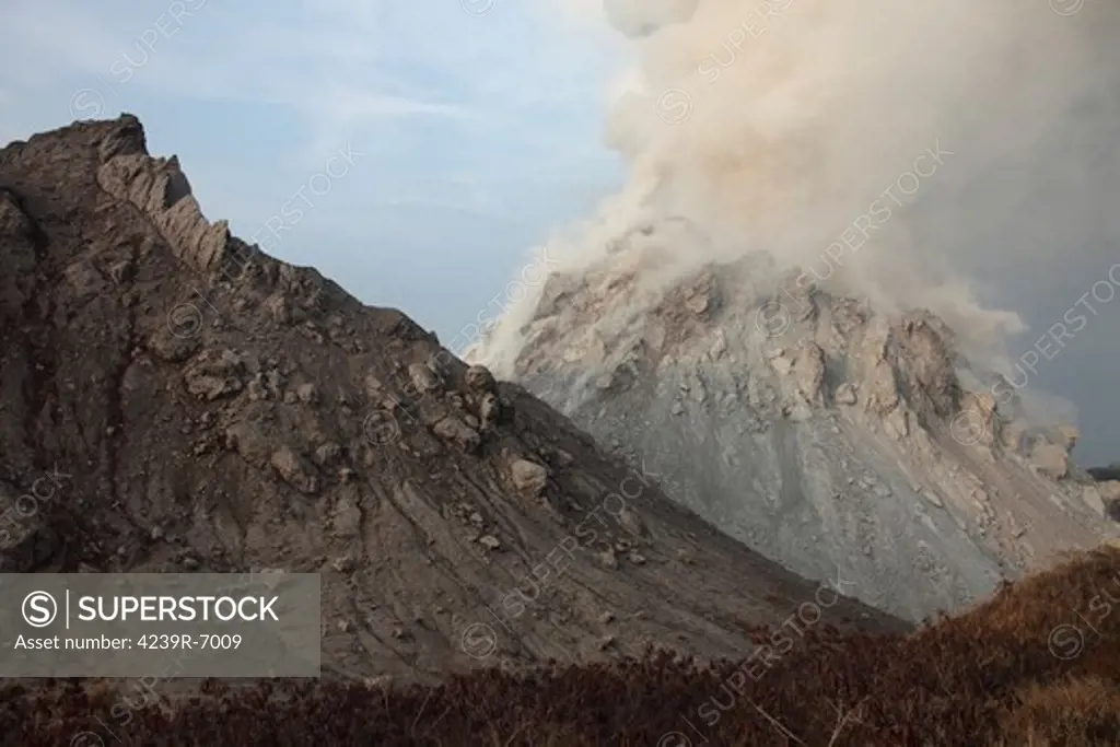 December 1, 2012 - Degassing Rerombola lava dome of Paluweh volcano with older Rokatenda dome in foreground, Flores, Indonesia.