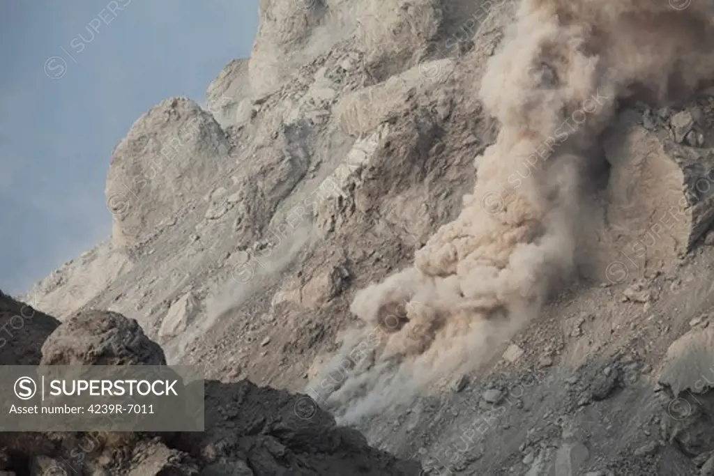 December 1, 2012 - Small rockfall on flank of Rerombola lava dome of Paluweh volcano during eruption in 2012, Flores, Indonesia.
