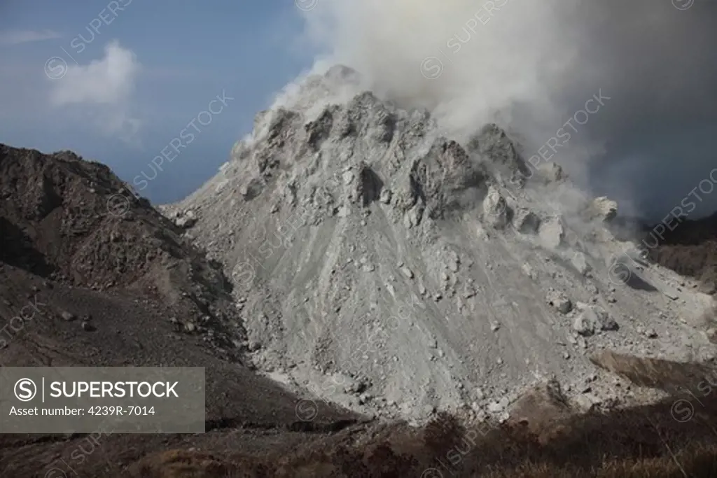 December 1, 2012 - Degassing Rerombola lava dome of Paluweh volcano during 2012 eruption with older Rokatenda dome to left, Flores, Indonesia.