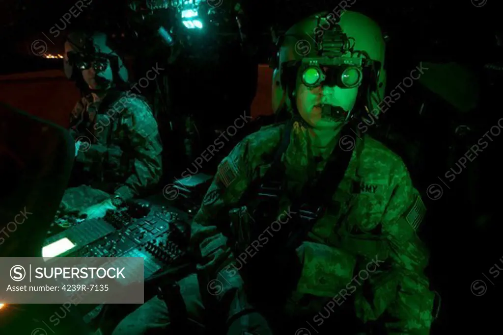 Pilots equipped with night vision goggles in the cockpit of a UH-60 Black Hawk helicopter at Davis Monthan Air Force Base, Arizona.