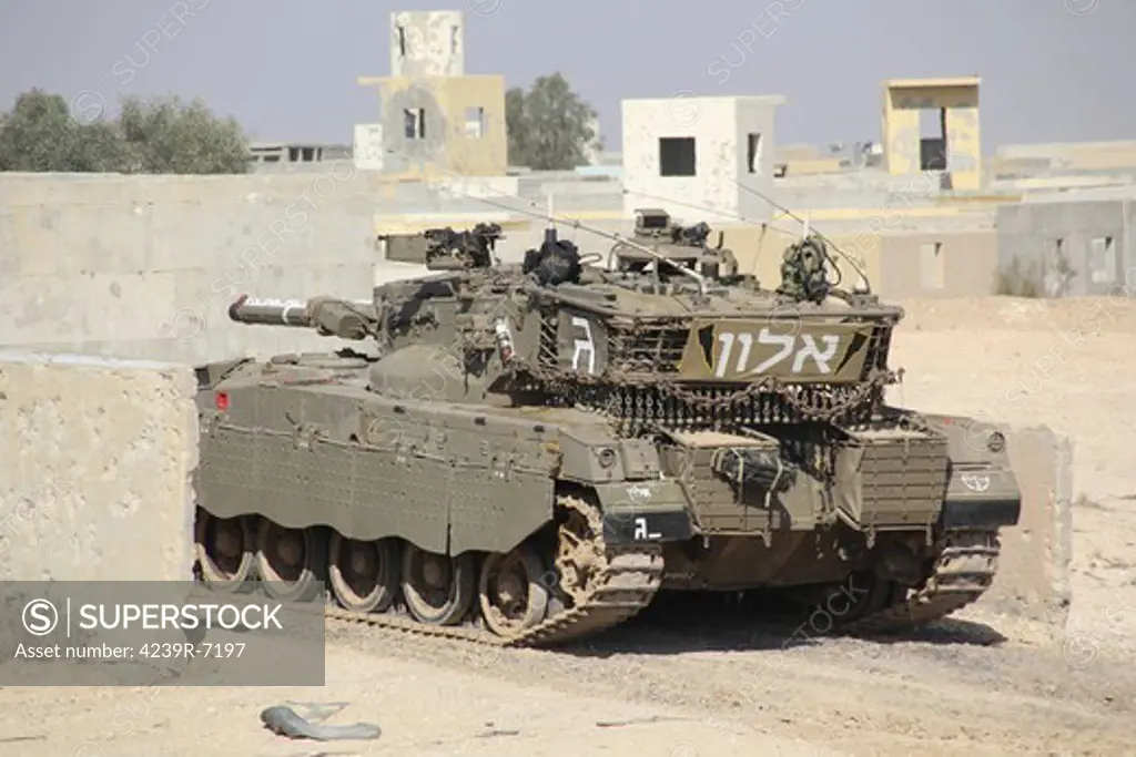 An Israel Defense Force Merkava Mark II main battle tank demonstrates urban warfare techniques.