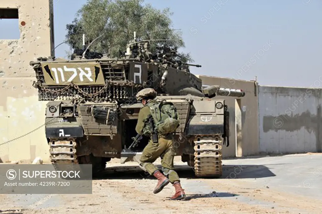 An Israel Defense Force Merkava Mark II main battle tank demonstrates urban warfare techniques.