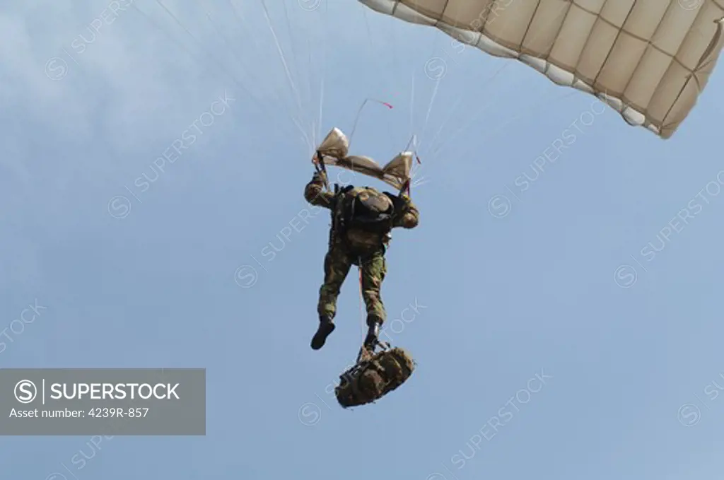 A member of the British Army Pathfinder Platoon prepares to land from a parachute jump