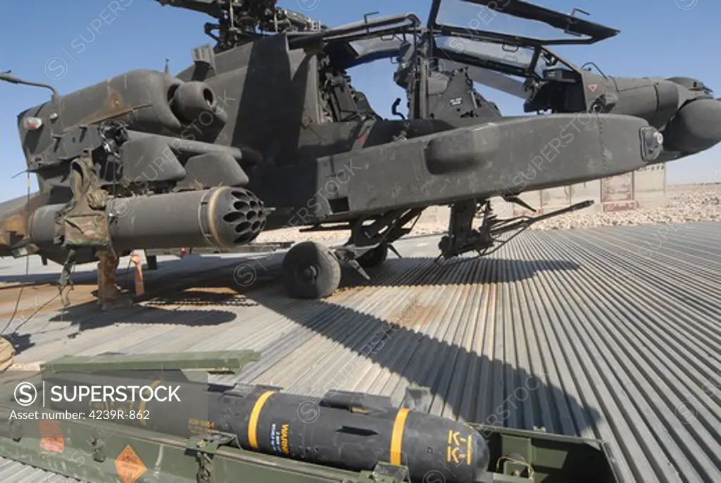 An AGM-114 Hellfire missile is ready to be loaded onto an Apache helicopter