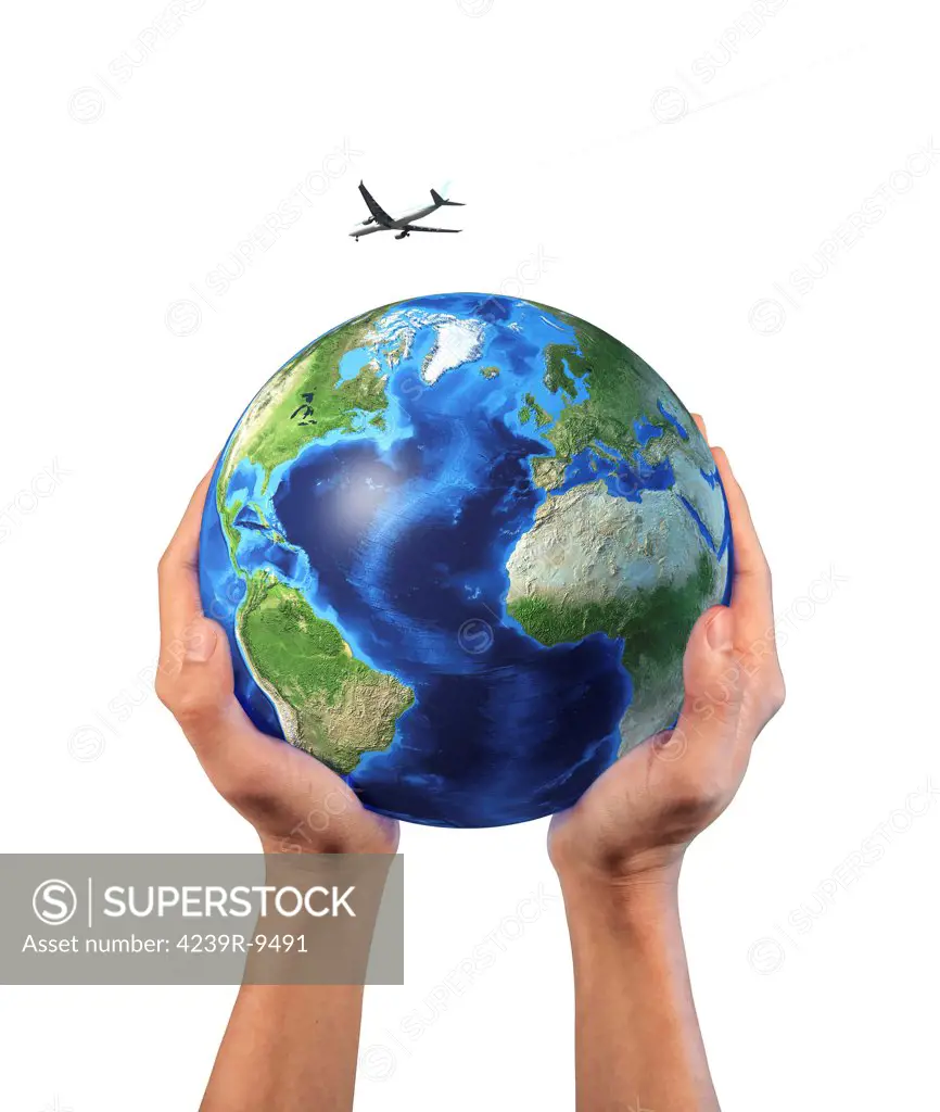 Man's hands holding the planet Earth, with a jet aircraft flying above.