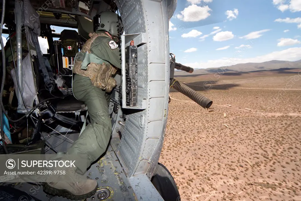 An HH-60G Pave Hawk gunner of the 512th Rescue Squadron, fires his GAU-17/A during live fire exercises at the White Sands Missile Range, Kirtland Air Force Base, New Mexico.