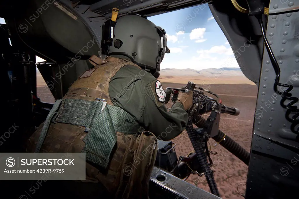 An HH-60G Pave Hawk gunner of the 512th Rescue Squadron, fires his GAU-17/A during live fire exercises at the White Sands Missile Range, Kirtland Air Force Base, New Mexico.
