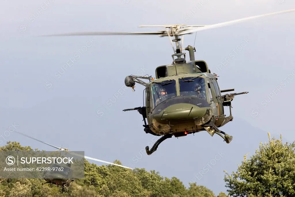 Two Italian Air Force AB-212 ICO helicopters practice low level flying in the valleys near Naples, Italy. Both helicopters are armed with MG 42/59 7.62mm machine guns.