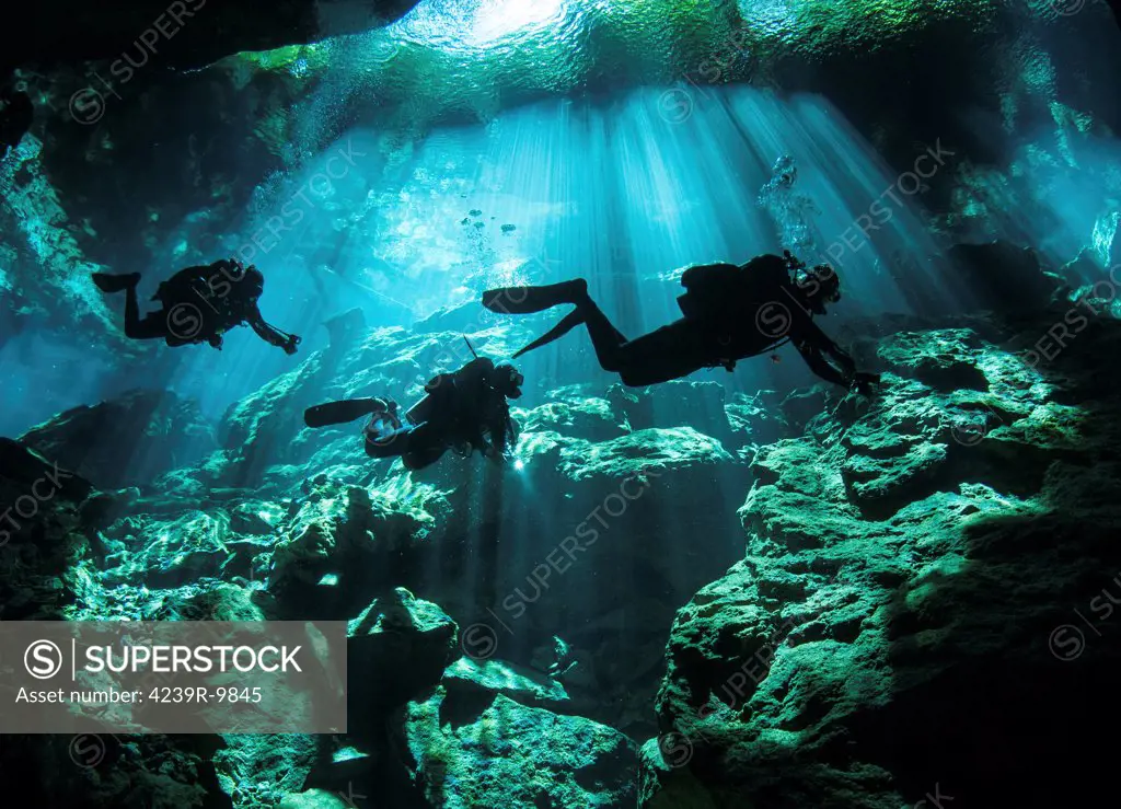Diver enters the cavern system at Chac Mool cenote in the Riviera Maya area of Mexico's Yucatan Peninsula.