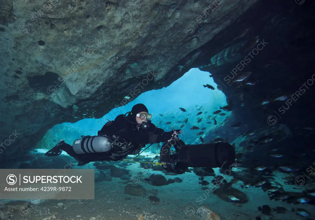 A technical cave diver using a diver propulsion vehicle (DPV) to dive into the Blue Springs state park cave system near Marianna, Florida.