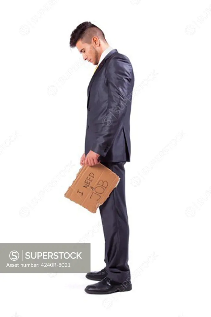 Young Businessman Holding A Piece Of Cardboard Saying He Needs A Job