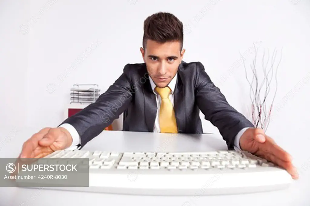 Businessman At His Office Typing At The Computer Keyboard