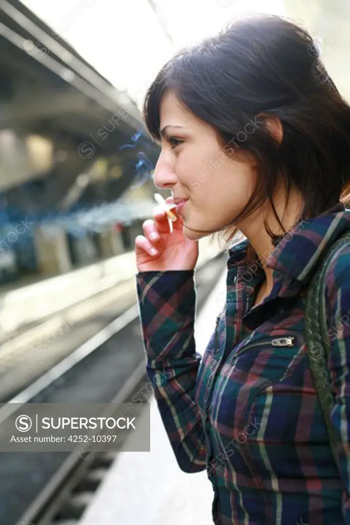 Woman smoking train station