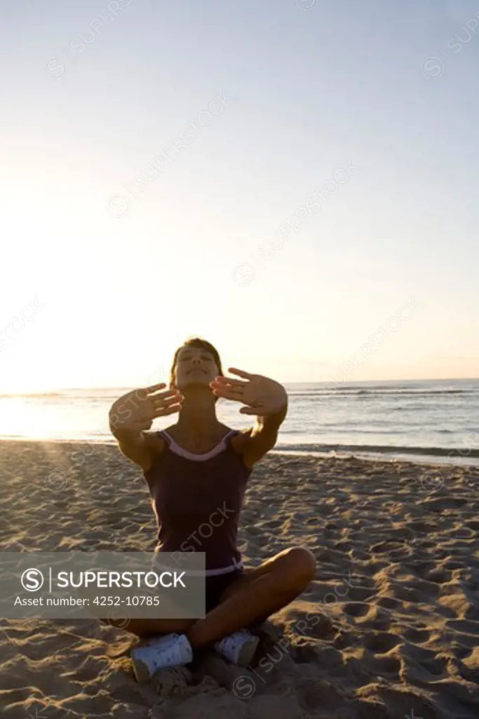 Woman yoga beach.