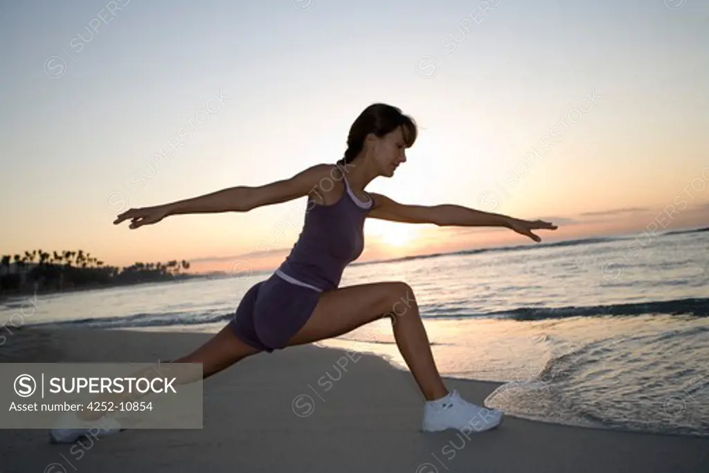 Woman gymnastics beach.
