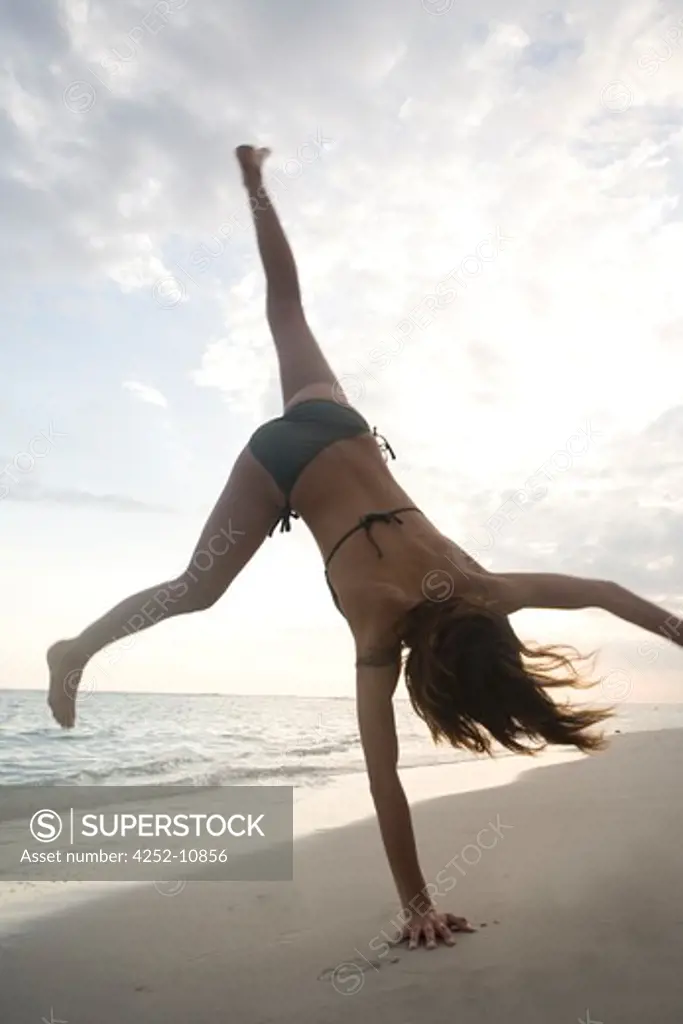 Woman cartwheel beach