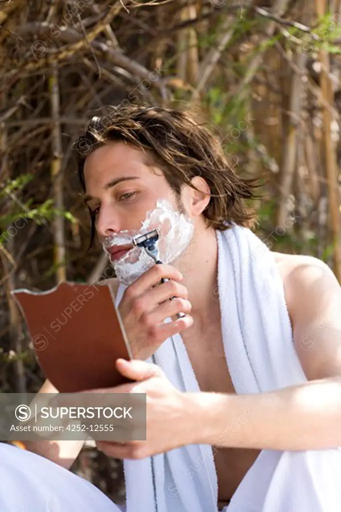 Man outside shaving