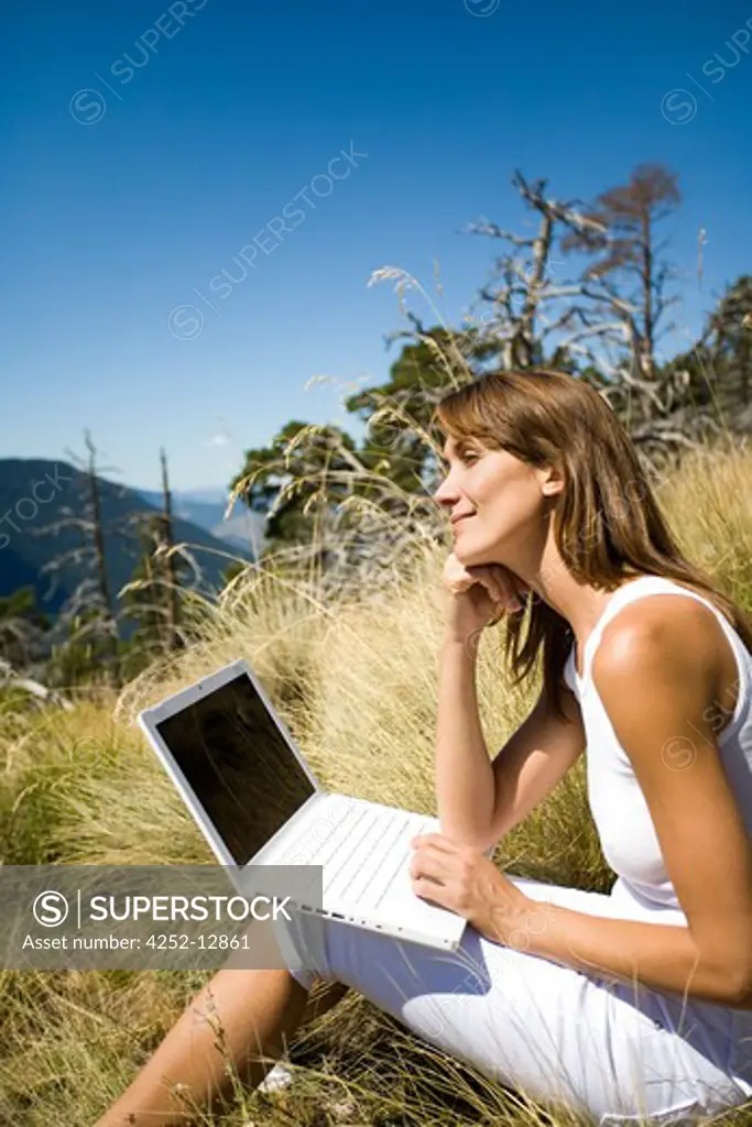 Woman nature laptop.