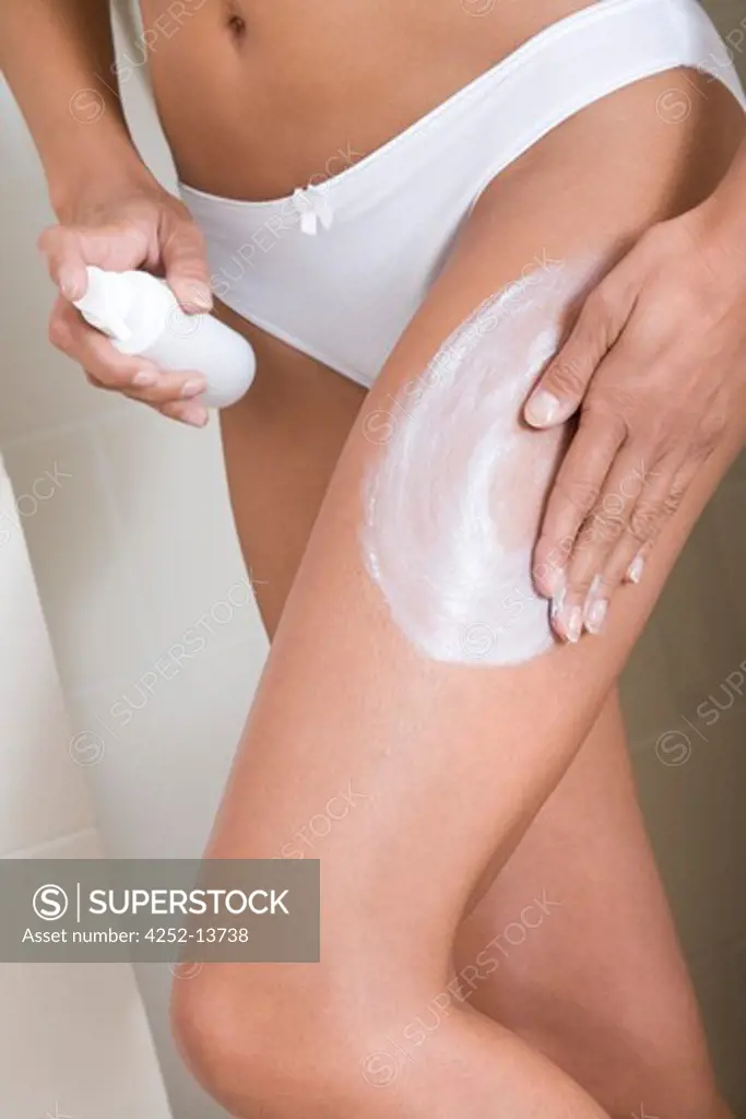 Woman moisturizing.