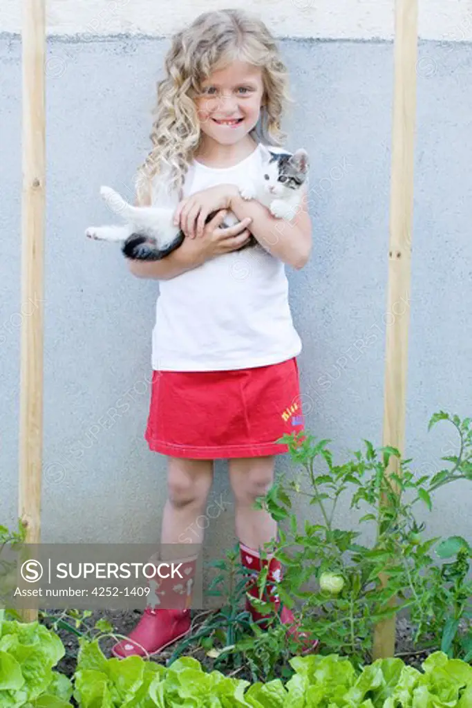 Little girl garden kitten
