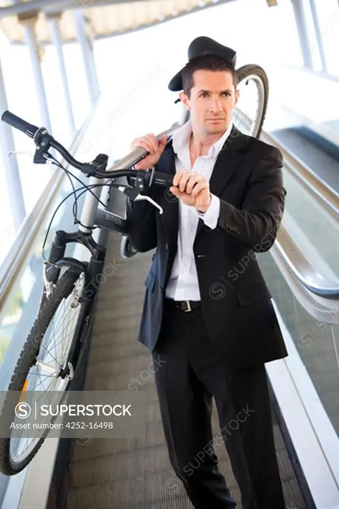 Man bike escalator