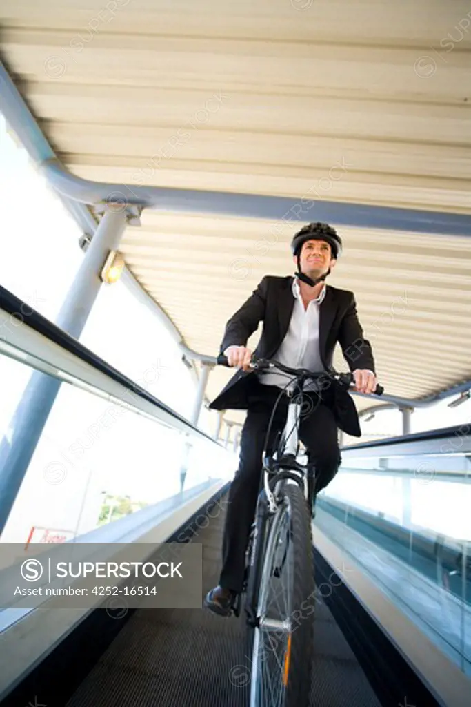 Man bike escalator