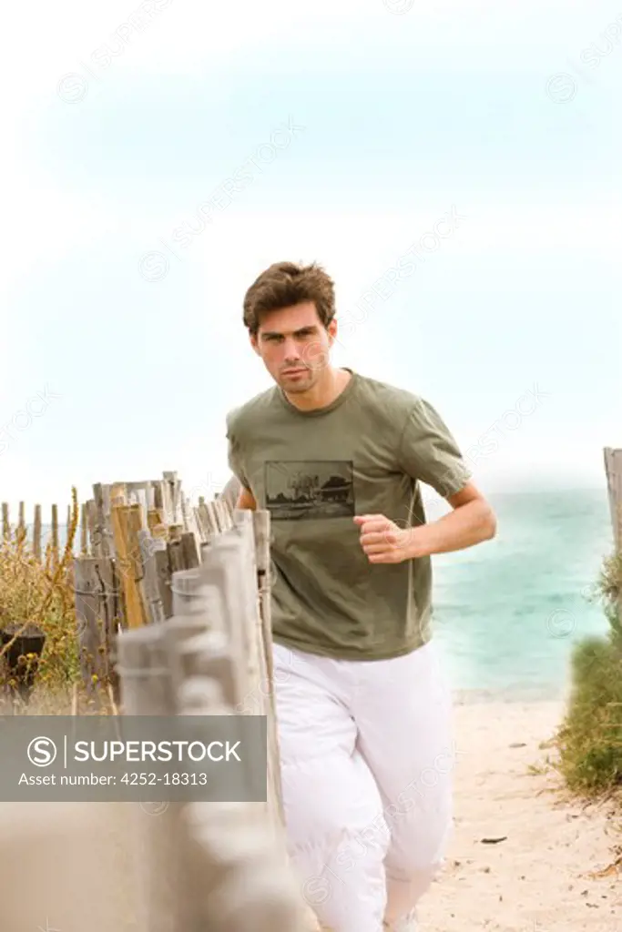 Man beach jogging