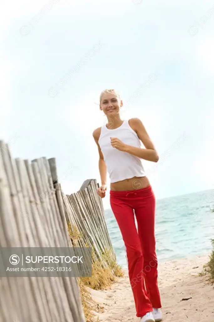 Woman beach jogging