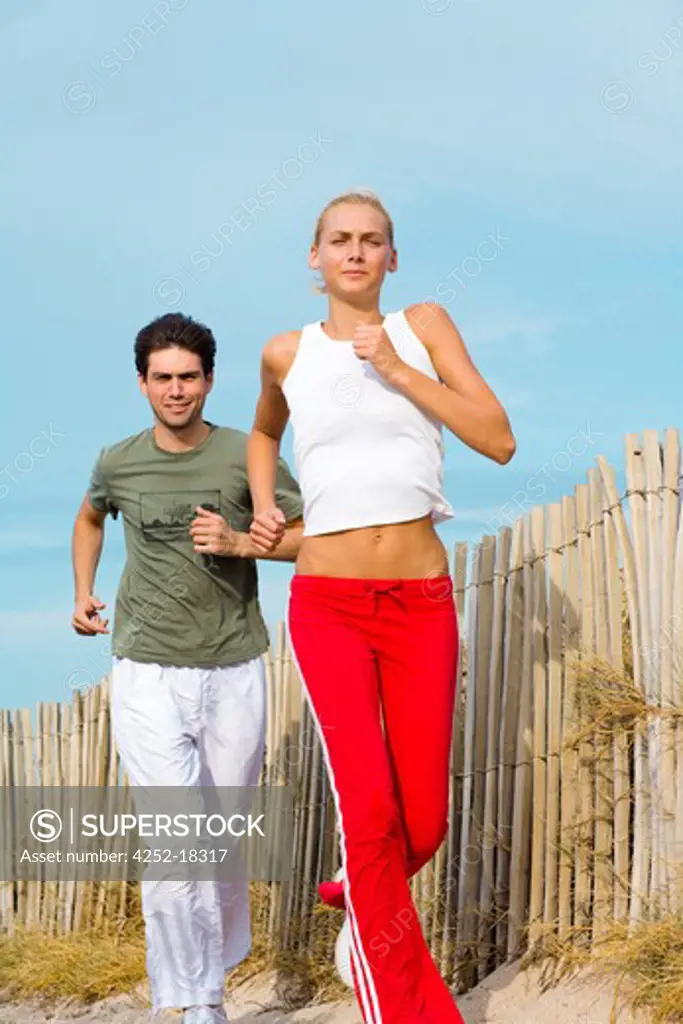 Couple beach jogging
