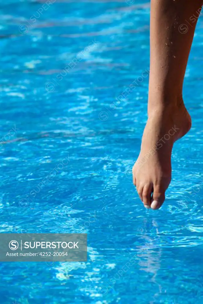 Woman feet pool water