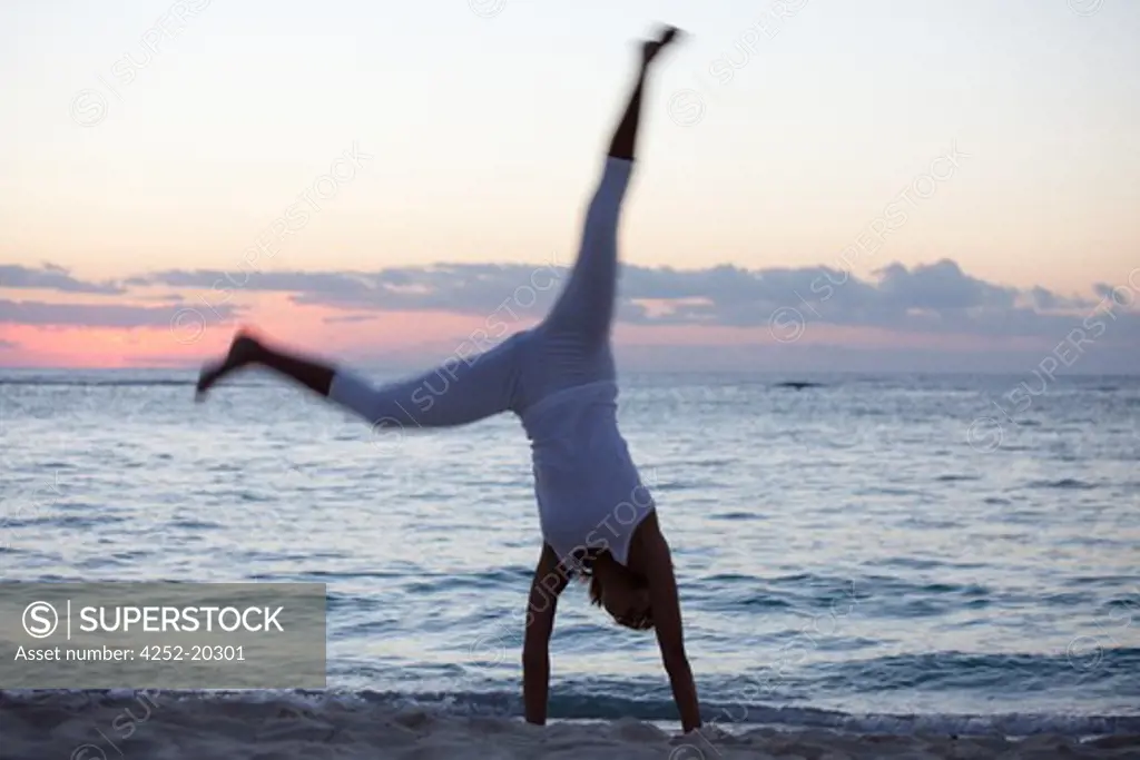 Woman beach cartwheel
