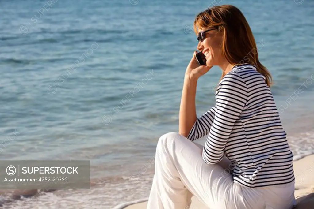 Woman beach phone